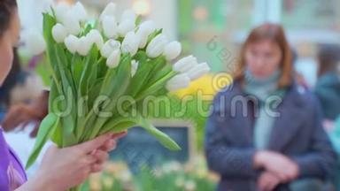 一个女人在花市收集一束郁金香。 鲜花发货，订单创建，微商..